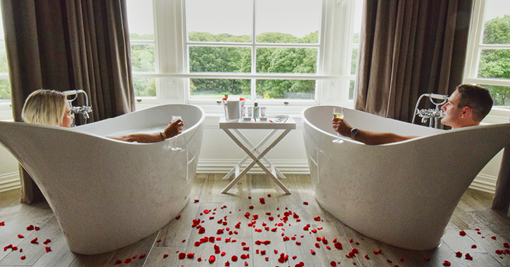 couple relaxing in matching baths at Seaham Hall Hotel